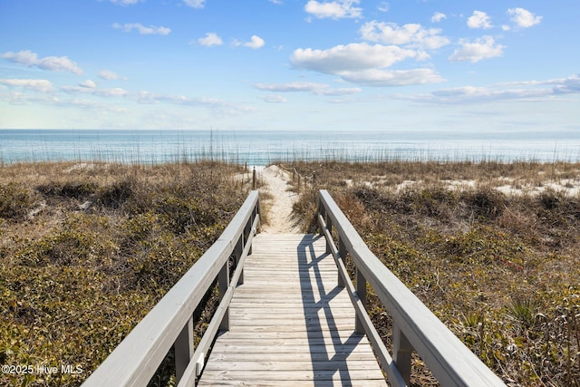 view of home's community featuring a beach view and a water view