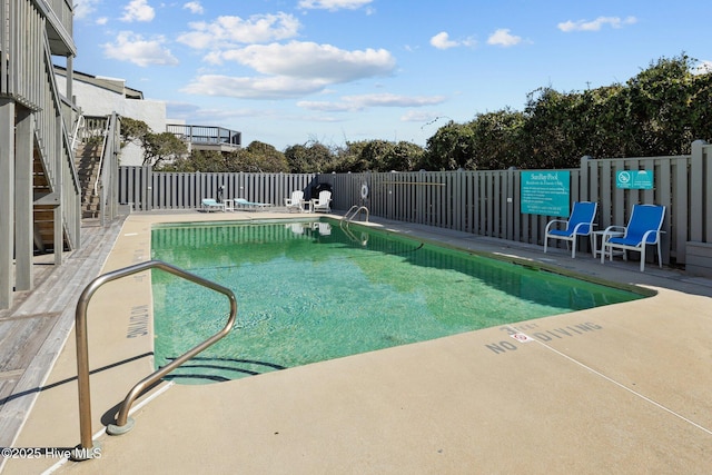 pool featuring fence and a patio