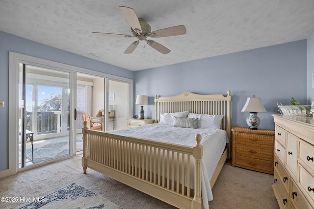 bedroom featuring a textured ceiling, ceiling fan, light colored carpet, and access to exterior