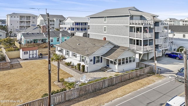 view of building exterior with a fenced backyard and a residential view