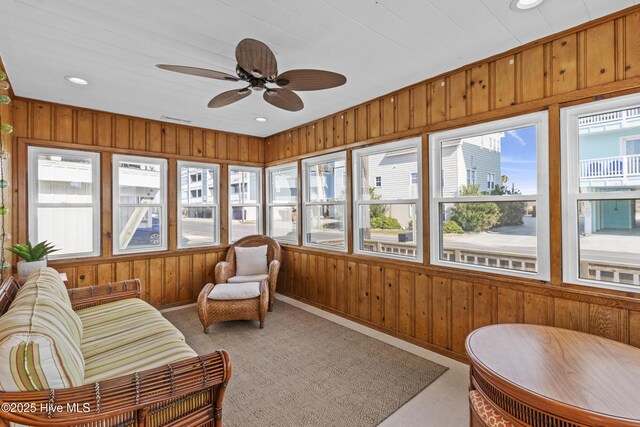 interior space with ceiling fan