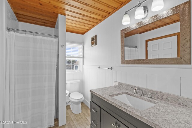 full bath with wooden ceiling, toilet, a wainscoted wall, vanity, and tiled shower