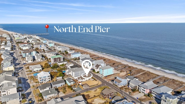 drone / aerial view featuring a beach view, a water view, and a residential view