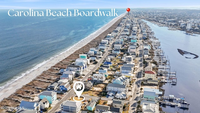 drone / aerial view featuring a water view and a view of the beach