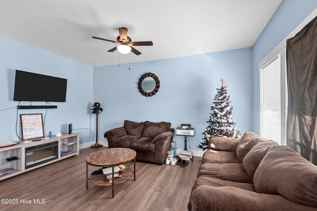 living room with wood finished floors and ceiling fan