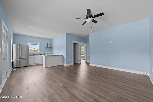 105 Bryan Pl, Washington, NC 27889 - unfurnished living room featuring a sink, dark wood-style floors, a ceiling fan, and baseboards