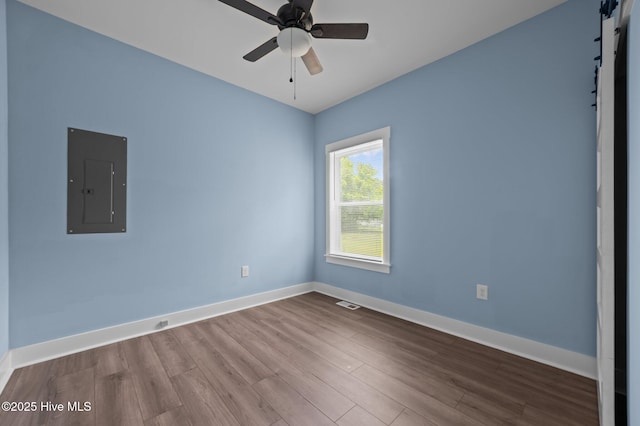 105 Bryan Pl, Washington, NC 27889 - spare room with electric panel, wood finished floors, baseboards, ceiling fan, and a barn door