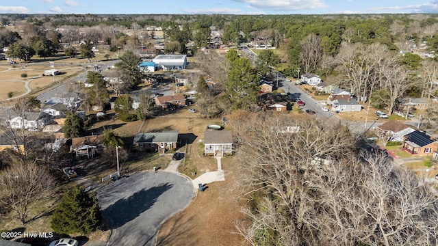 bird's eye view with a wooded view