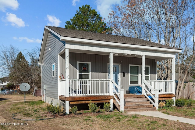 bungalow with a porch and board and batten siding