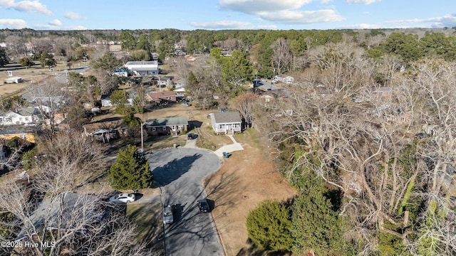 birds eye view of property with a wooded view