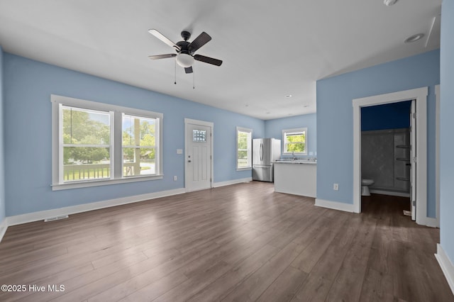 105 Bryan Pl, Washington, NC 27889 - unfurnished living room featuring ceiling fan, dark wood finished floors, and baseboards