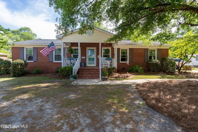 ranch-style home with a porch, crawl space, and brick siding