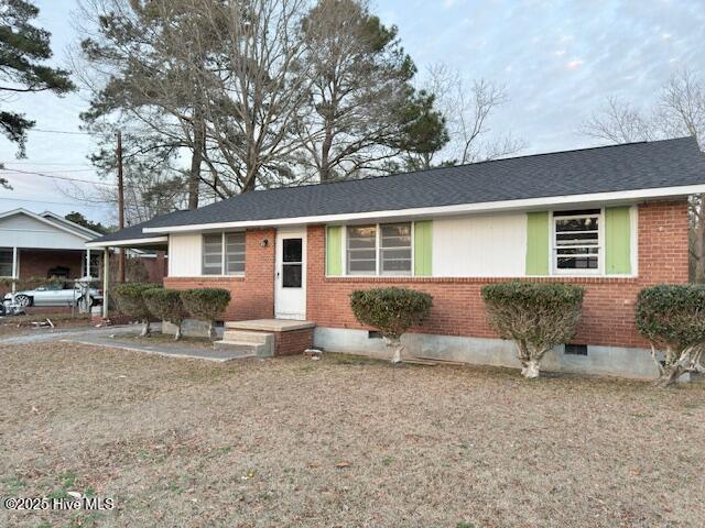 ranch-style home with crawl space, a carport, and brick siding