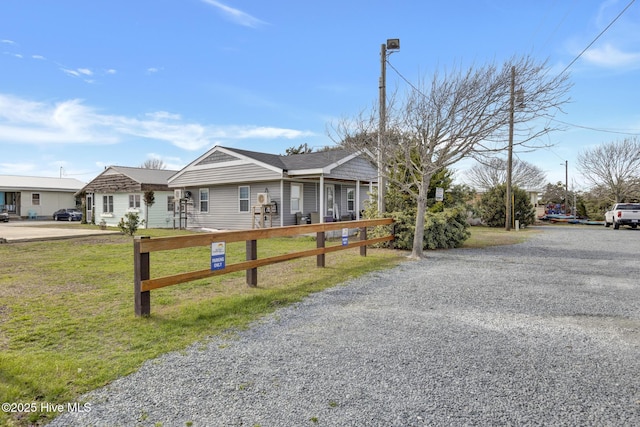 view of front facade with a front yard and fence