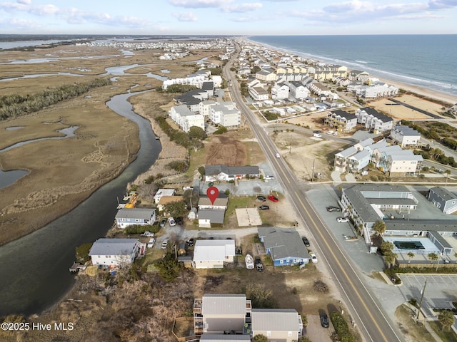 bird's eye view featuring a beach view, a water view, and a residential view