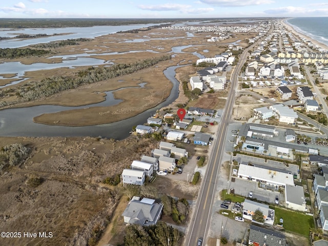 birds eye view of property with a water view and a residential view