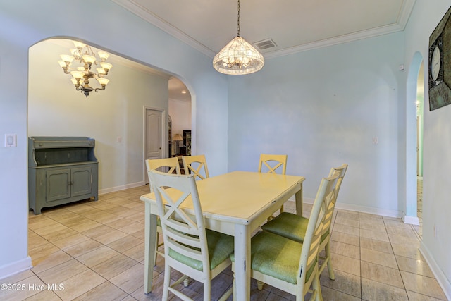 dining area featuring arched walkways, ornamental molding, a chandelier, and visible vents