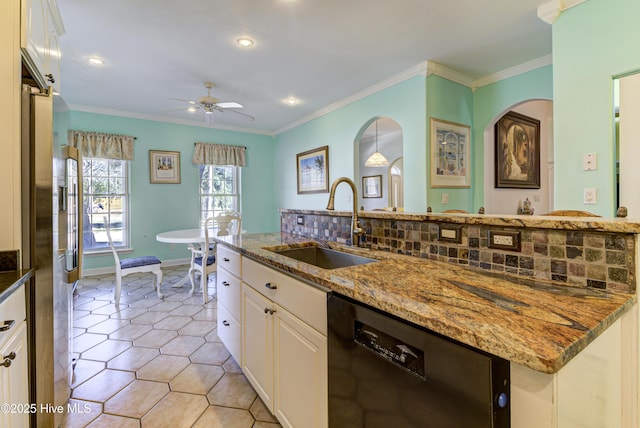 kitchen with dark stone countertops, white cabinets, dishwasher, and a sink