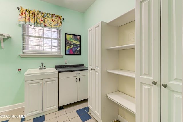 bathroom featuring tile patterned flooring and vanity