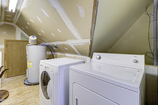 washroom featuring laundry area, independent washer and dryer, electric water heater, and light wood-style floors