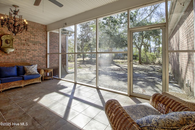 sunroom / solarium with a ceiling fan