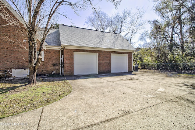 garage with fence and cooling unit