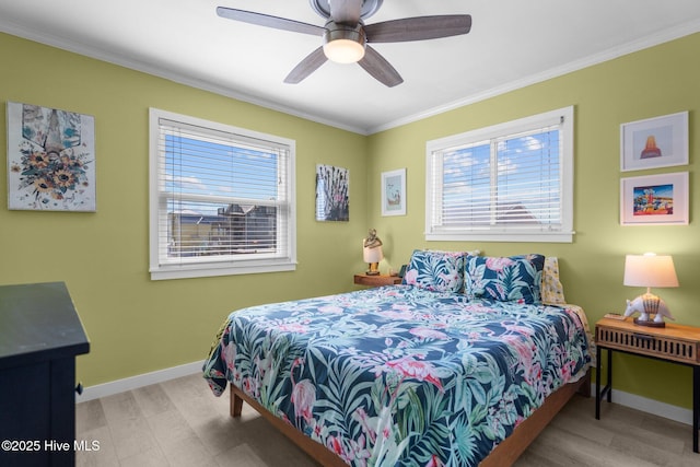 bedroom with ornamental molding, ceiling fan, baseboards, and wood finished floors