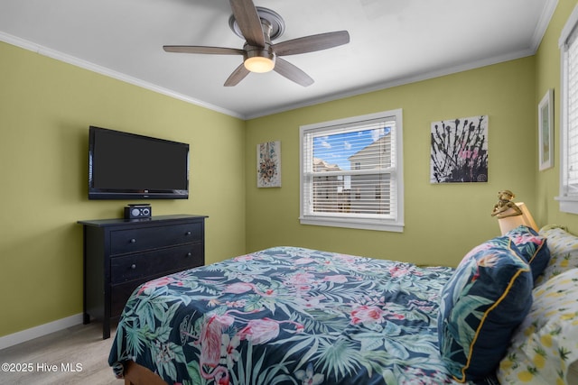 bedroom with ornamental molding, ceiling fan, and baseboards