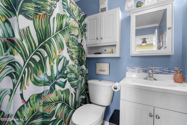 bathroom with toilet, a shower with curtain, crown molding, and vanity