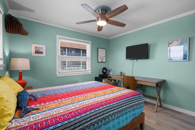 bedroom with multiple windows, ornamental molding, and wood finished floors