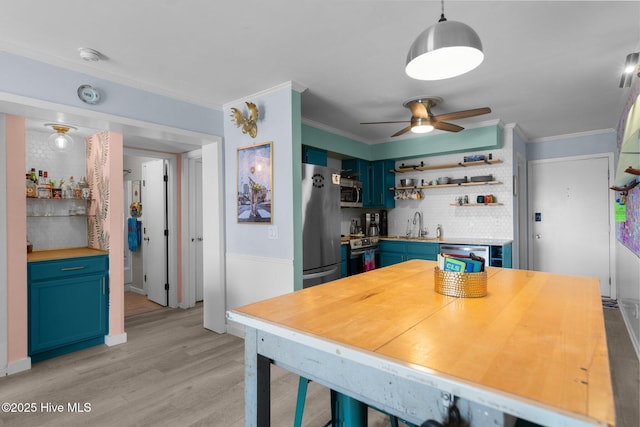 kitchen featuring light wood-style floors, appliances with stainless steel finishes, open shelves, and crown molding