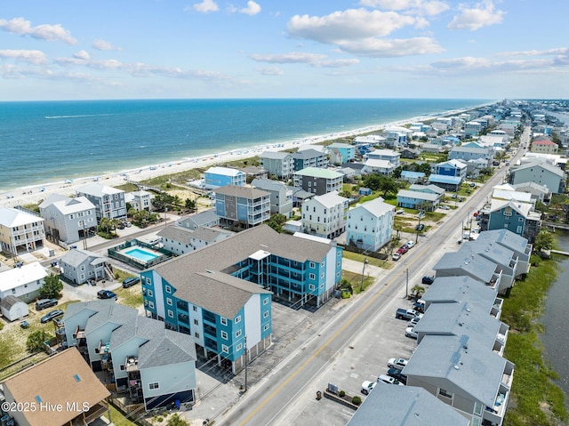 drone / aerial view featuring a water view and a beach view