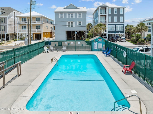 view of pool featuring fence