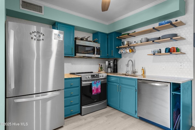 kitchen with open shelves, appliances with stainless steel finishes, visible vents, and blue cabinets