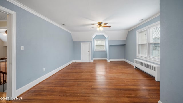 bonus room featuring radiator, ceiling fan, baseboards, and dark wood finished floors