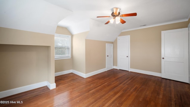 bonus room with vaulted ceiling, dark wood finished floors, a ceiling fan, and baseboards