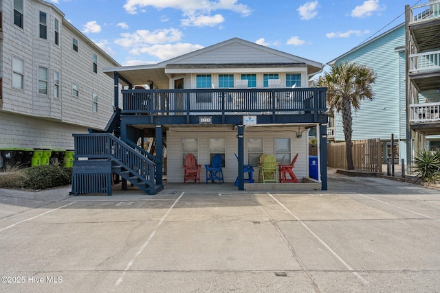 view of front of house featuring fence and stairway