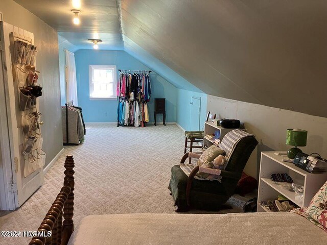 bedroom featuring lofted ceiling, carpet flooring, and baseboards