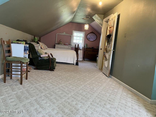 carpeted bedroom featuring lofted ceiling and baseboards