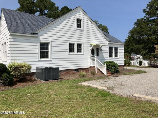 spare room with baseboards, baseboard heating, and wood finished floors