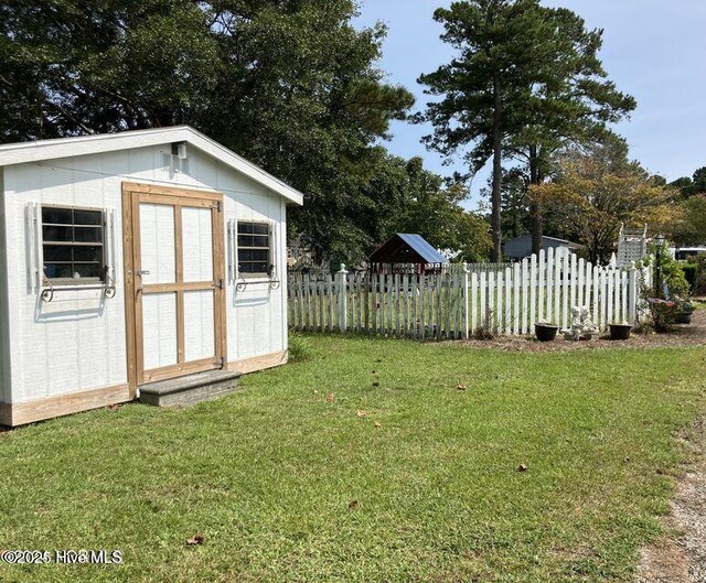 rear view of property with a yard, fence, cooling unit, and roof with shingles