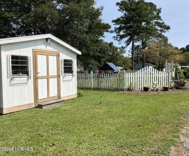 view of shed featuring fence