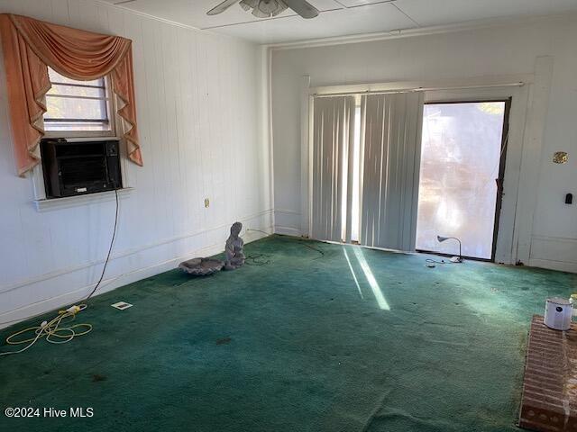 spare room with carpet, cooling unit, a ceiling fan, and crown molding