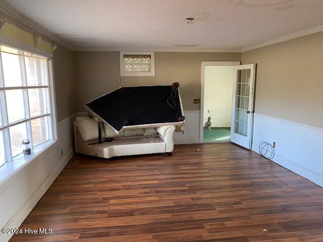 bedroom featuring dark wood-type flooring and crown molding