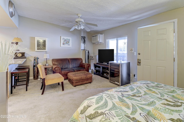 carpeted bedroom featuring a textured ceiling, a wall unit AC, and a ceiling fan