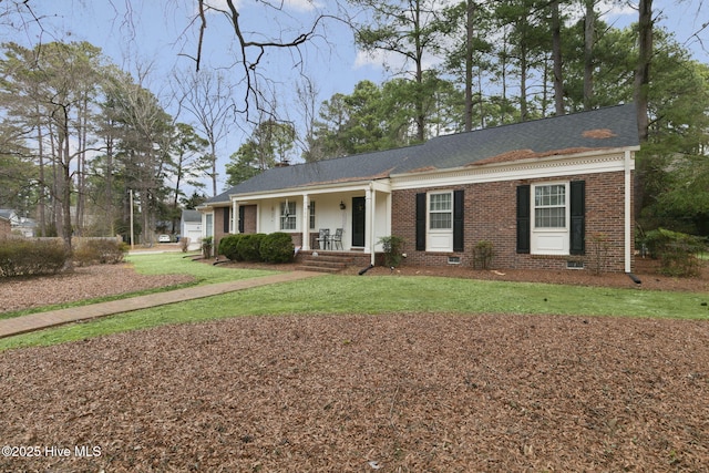 ranch-style home with covered porch, brick siding, and a front lawn