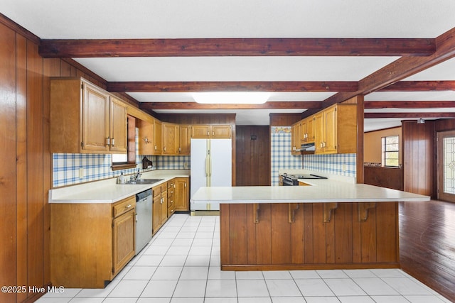 kitchen with electric range oven, dishwasher, freestanding refrigerator, light countertops, and a sink