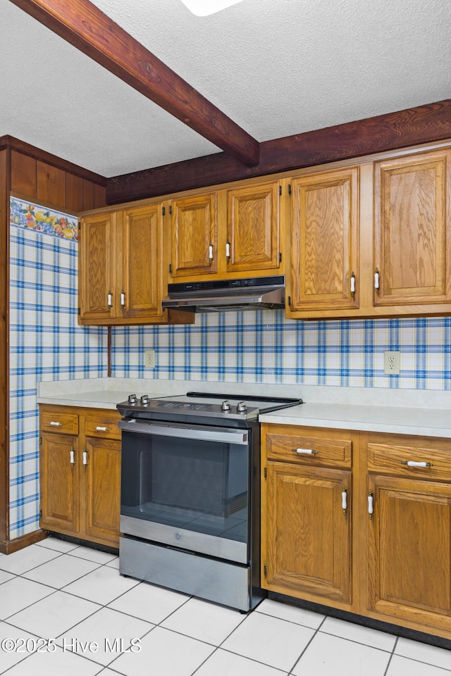 kitchen featuring a textured ceiling, light countertops, stainless steel range with electric stovetop, and under cabinet range hood