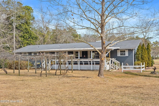 single story home with a front lawn and fence