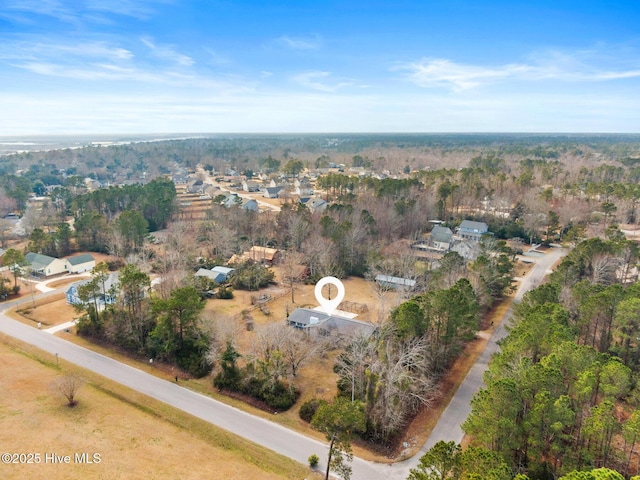 birds eye view of property with a forest view